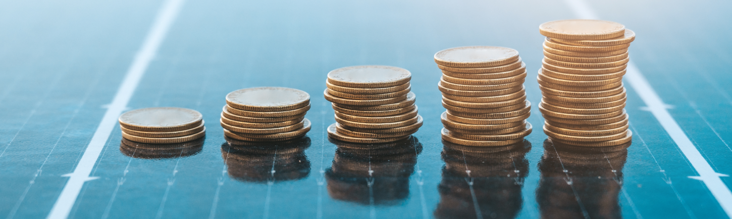 Finance and sustainability illustrated by coins and a solar panel