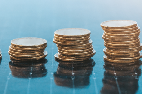 Finance and sustainability illustrated by coins and a solar panel